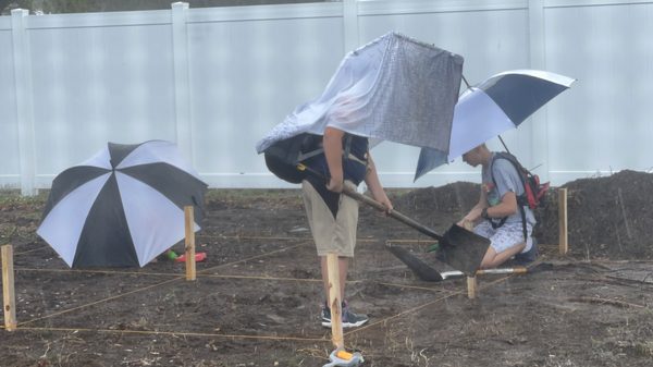 Comparing Prototype 1 (umbrella) and Prototype 2 (PVC) side by side in the rain